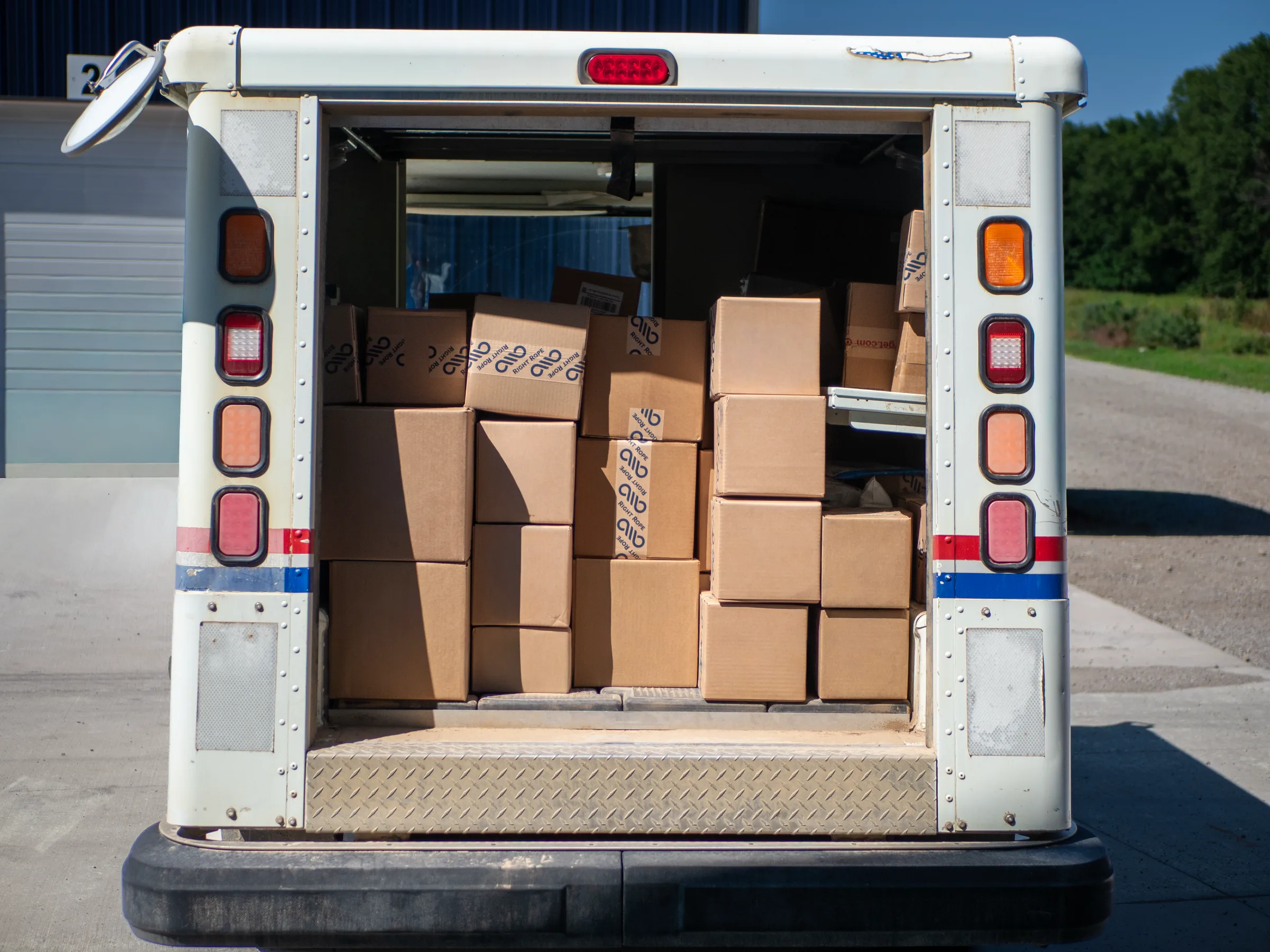 Shipped packages in the back of a mail truck