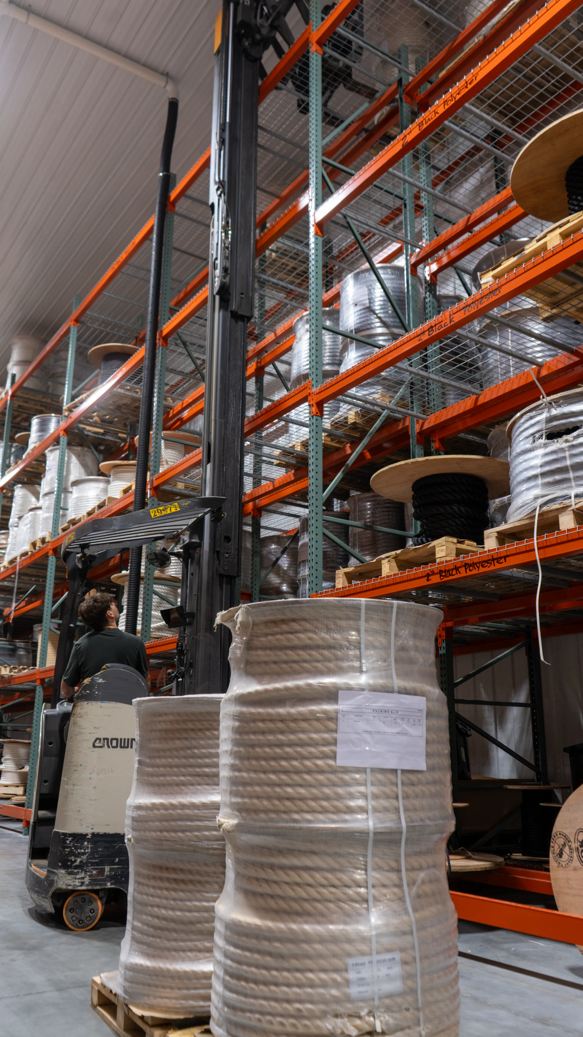 Employee putting pallet away in racking