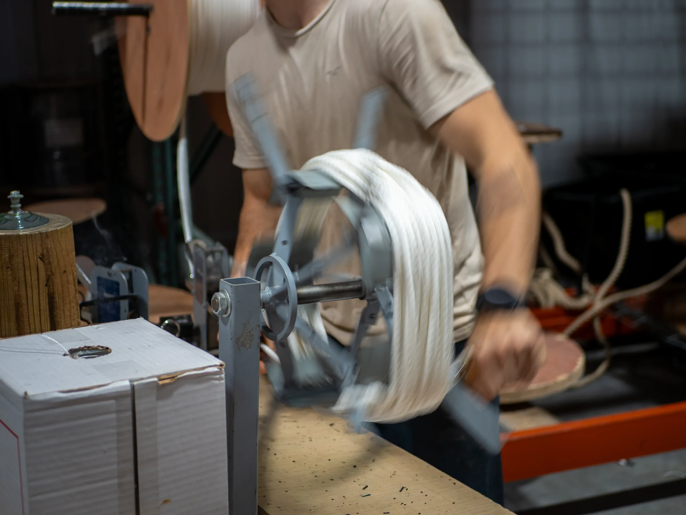 Employee manually coiling a small diameter rope quickly